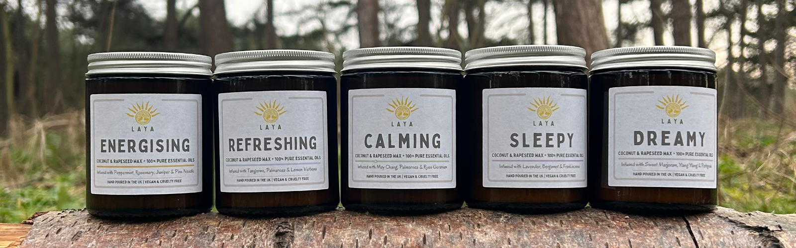 Laya Wellbeing candles outdoors, showcasing eco-friendly designs amid nature